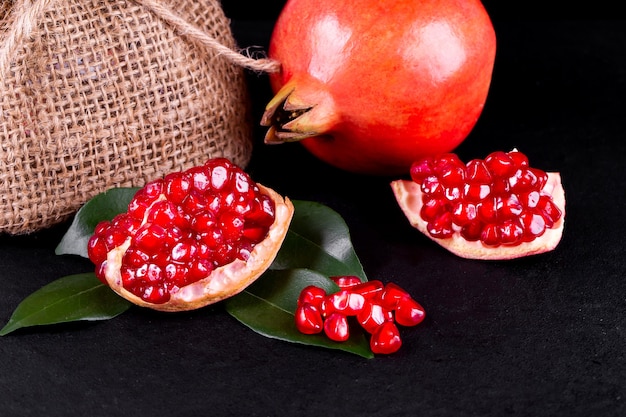 Ripe pomegranate fruits on the wooden background