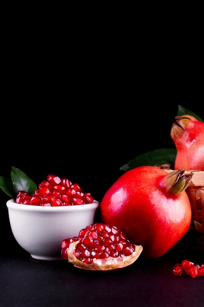 Ripe pomegranate fruits on the wooden background