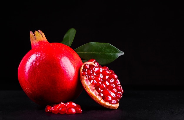 Ripe pomegranate fruits on the wooden background