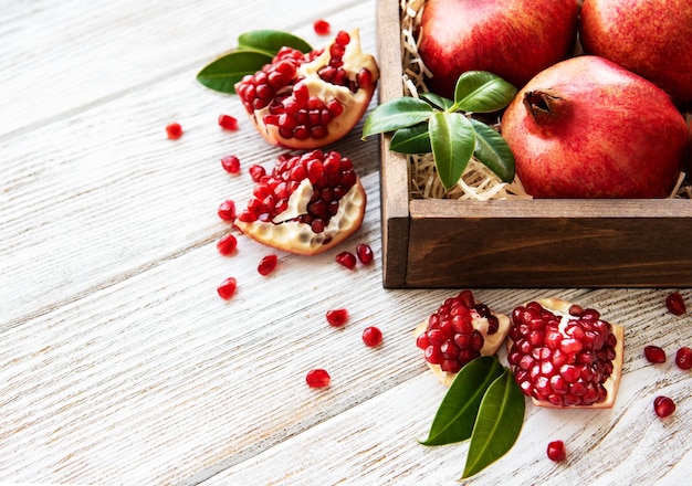 Ripe pomegranate fruits on wooden vintage background