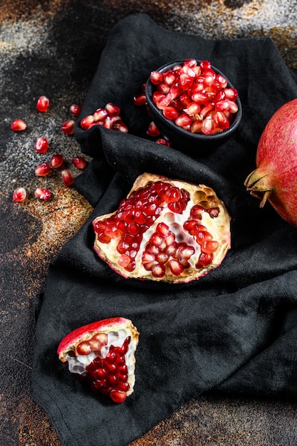 Ripe pomegranate. Organic fruit. Black background. Top view