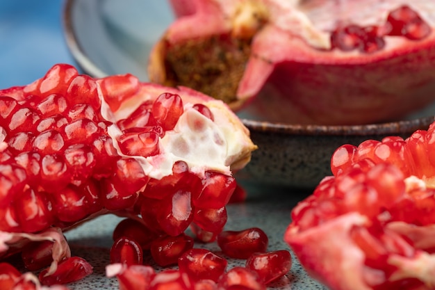 Ripe pomegranate on a table on a blue background