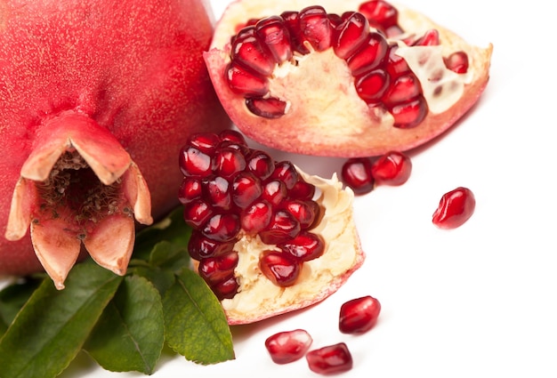 Ripe pomegranate with leaves on a wooden board