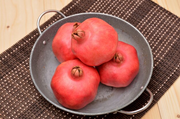 Ripe pomegranates  on a bamboo mat
