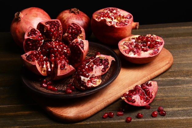 Ripe pomegranates on table closeup