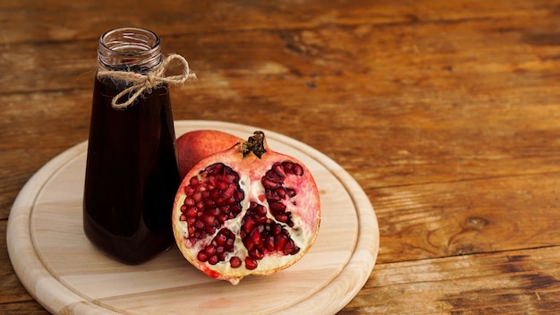 Ripe pomegranates with juice on wooden background