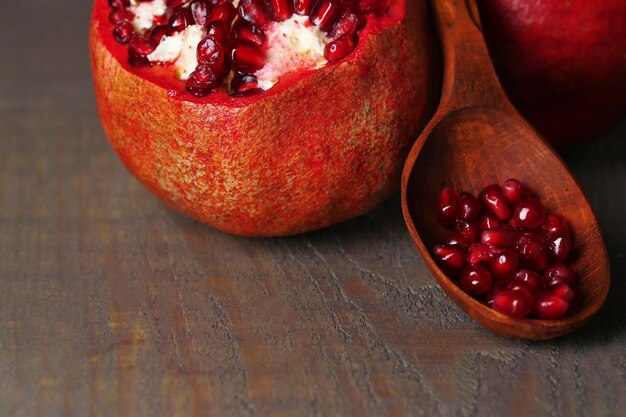 Ripe pomegranates on wooden background