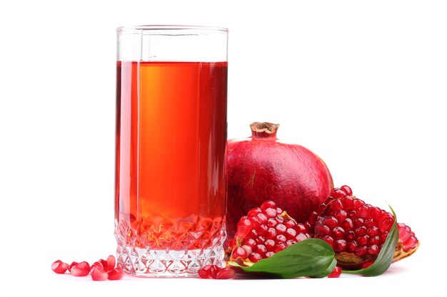 Ripe pomergranate and glass of juice isolated on white