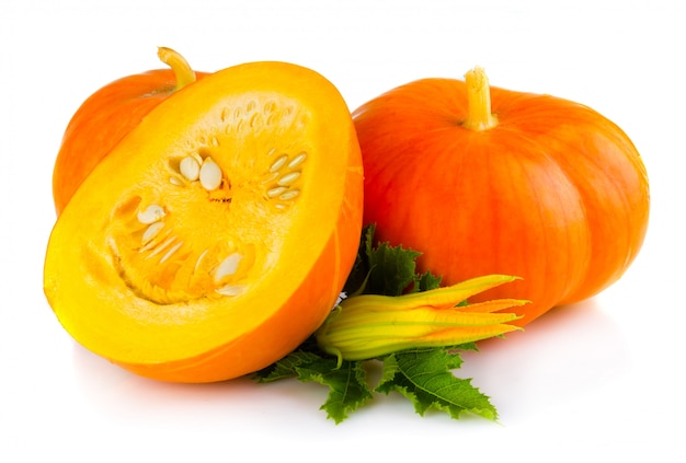 Ripe pumpkin vegetables with green leaves and blossom isolated