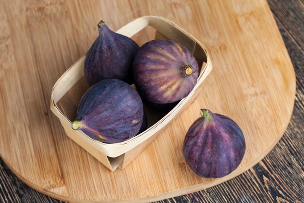 Ripe purple figs on a wooden table