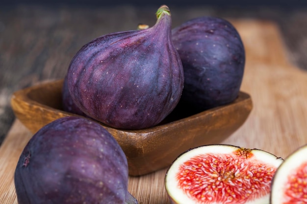 Ripe purple figs on a wooden table