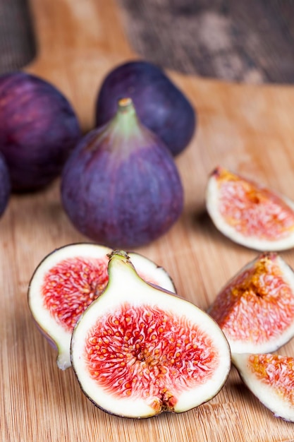 Ripe purple figs on a wooden table