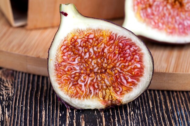 Ripe purple figs on a wooden table