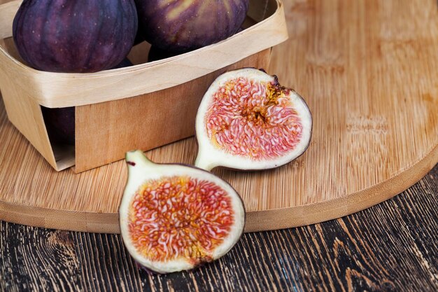 Ripe purple figs on a wooden table