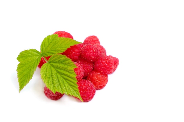 Ripe raspberry berry on a white background with a green leaf.