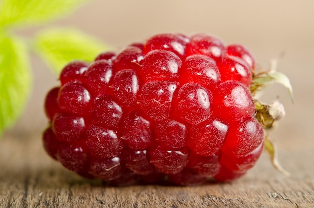 Ripe raspberry on wooden table