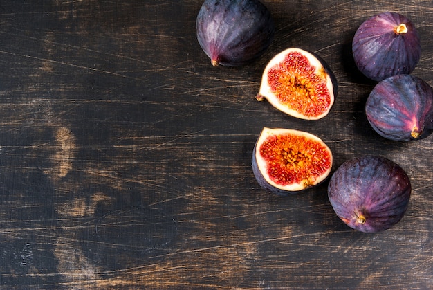 Ripe raw figs on a black wooden table