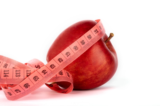 Ripe red apple and measuring meter