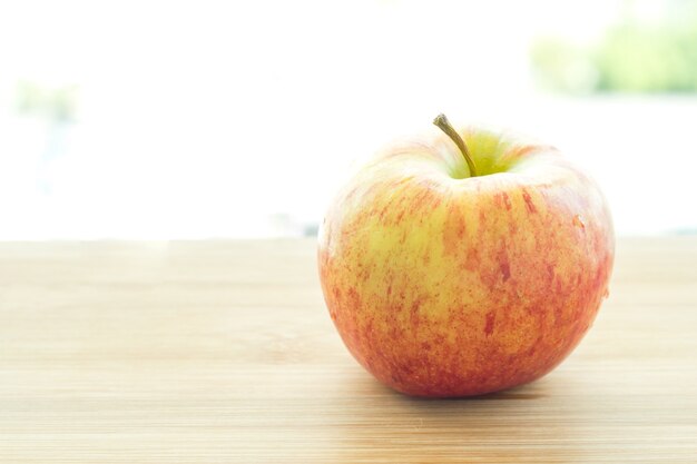 Ripe red apples on table close up.