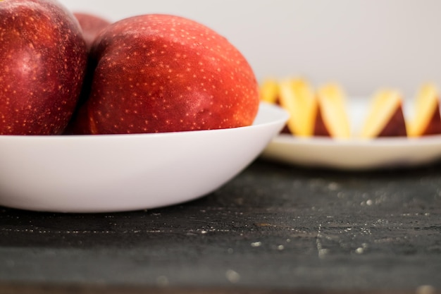 Ripe red apples with water drops on it on a dark background