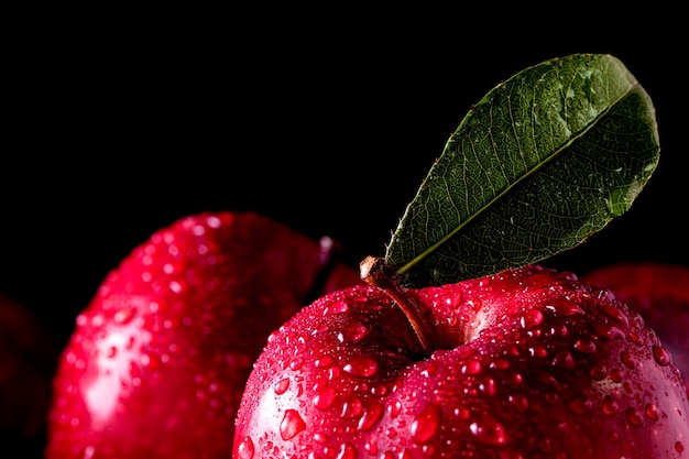 Ripe red apples on wooden background