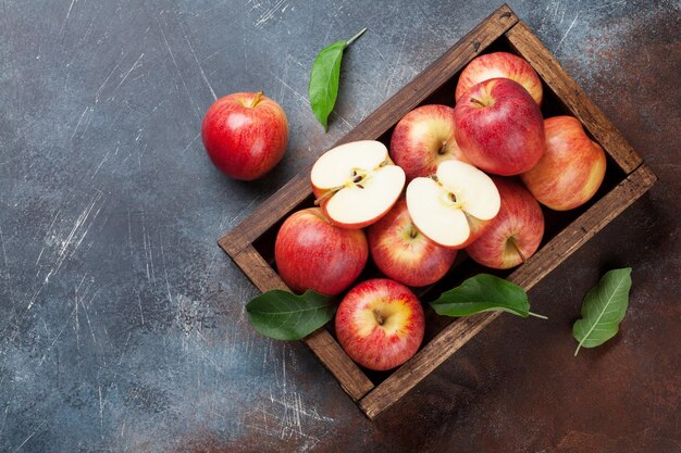 Ripe red apples in wooden box Top view with space for your text