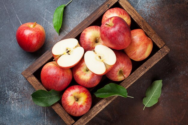 Ripe red apples in wooden box Top view