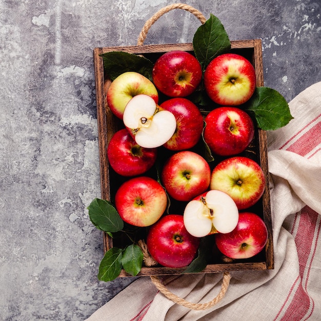 Ripe red apples in wooden box