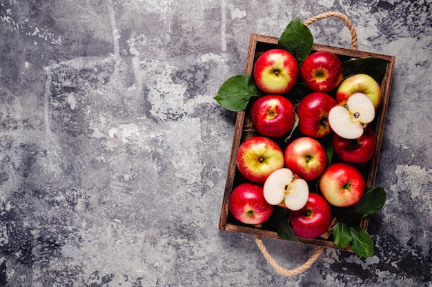 Ripe red apples in wooden box