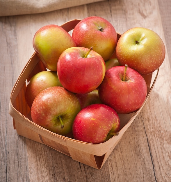 Ripe red apples on a wooden surface