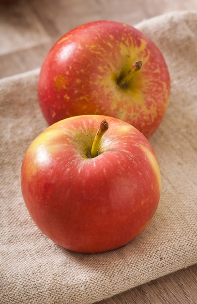 Ripe red apples on a wooden surface