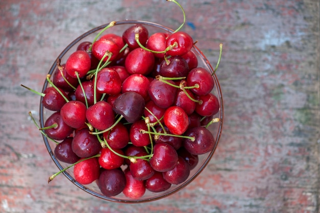 Ripe red cherries in a glass bowl