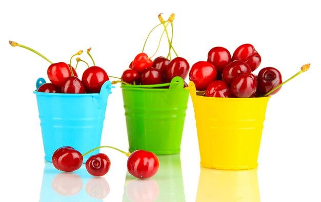 Ripe red cherry berries in pails isolated on white