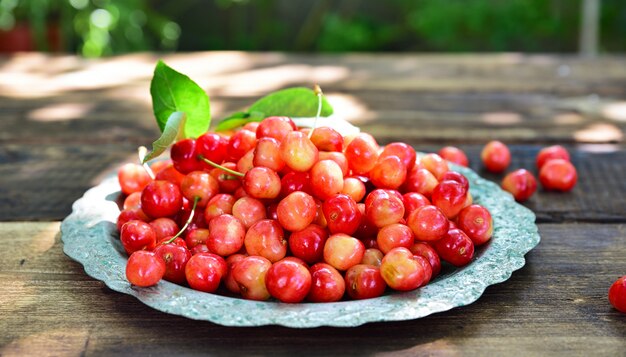 Ripe red cherry in an iron plate 