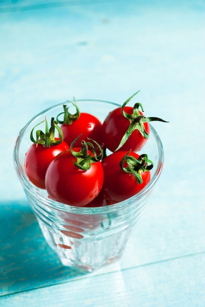 Ripe red cherry tomatoes in a glass