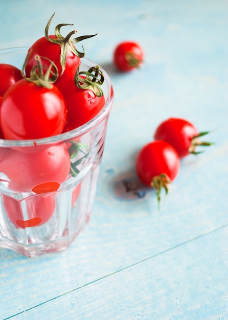 Ripe red cherry tomatoes in a glass