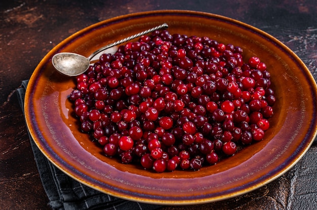 Ripe Red Cranberry berry in a rustic plate