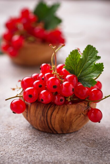 Ripe red currant berries in wooden bowls