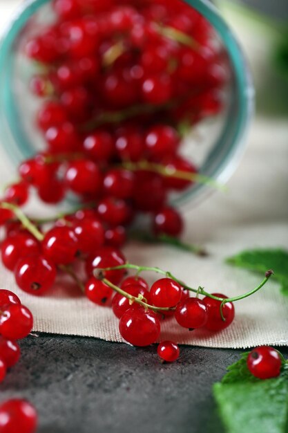 Ripe red currants on table closeup