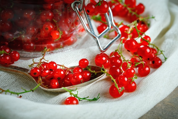 Ripe red currants on a wooden table.