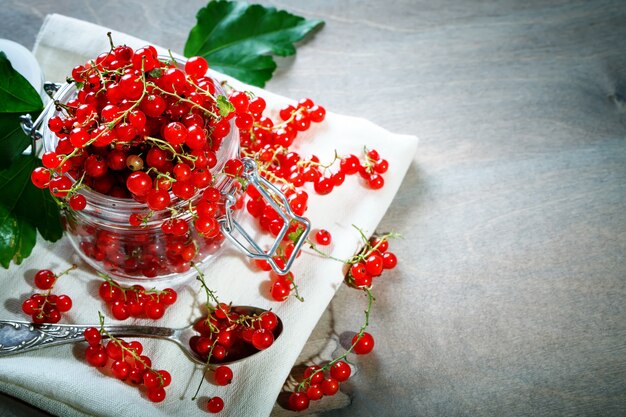 Ripe red currants on a wooden table.