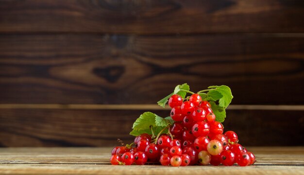 Ripe red currants on a wooden