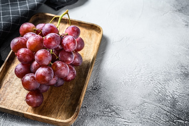 Ripe red grape. Pink bunch of ripe grape. White background