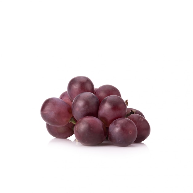 Ripe red grape with leaves isolated on white