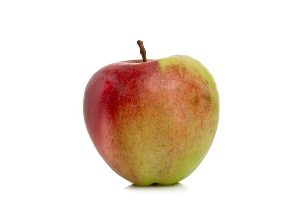 Ripe red-green apple. Harvest season. Vitamins and health from nature. Isolated on white background. Close-up.