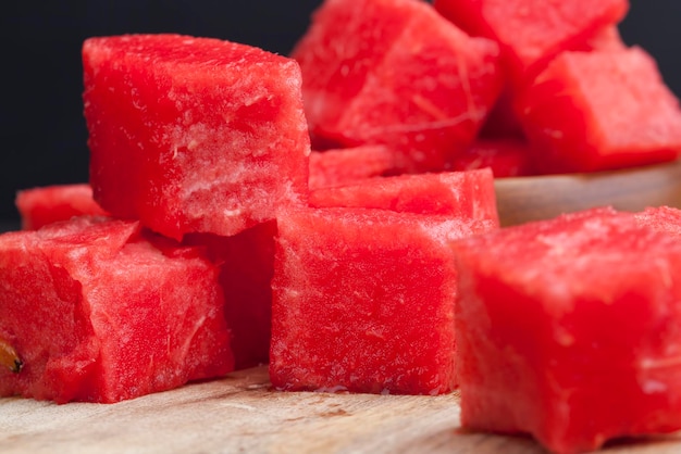 Ripe red juicy watermelon is cut into a large number of pieces, sliced red ripe watermelon