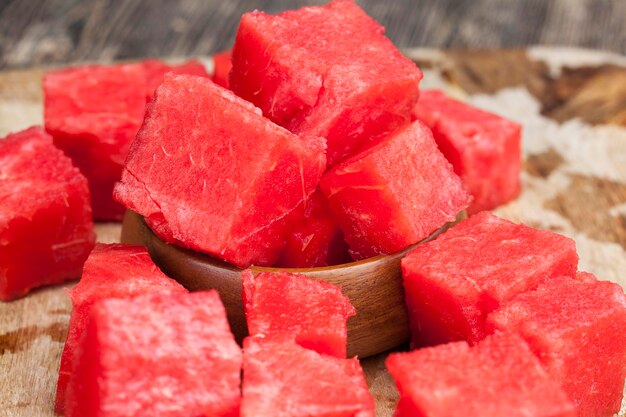 Ripe red juicy watermelon is cut into a large number of pieces
