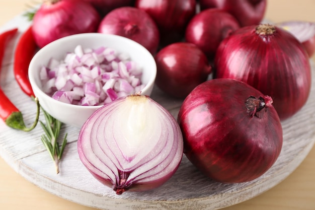 Ripe red onions on wooden board