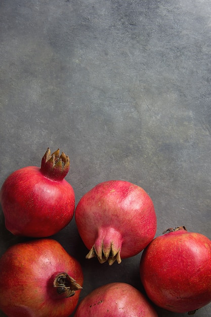 Ripe Red Organic Pomegranates on Black Stone