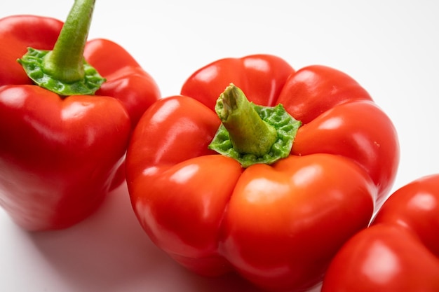 Ripe red peppers on a white background